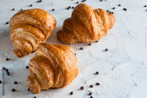 Croissant for breakfast. Chocolate crumbs.