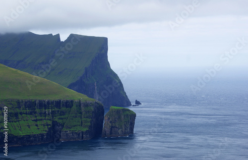 green clifs under a cloudy sky photo