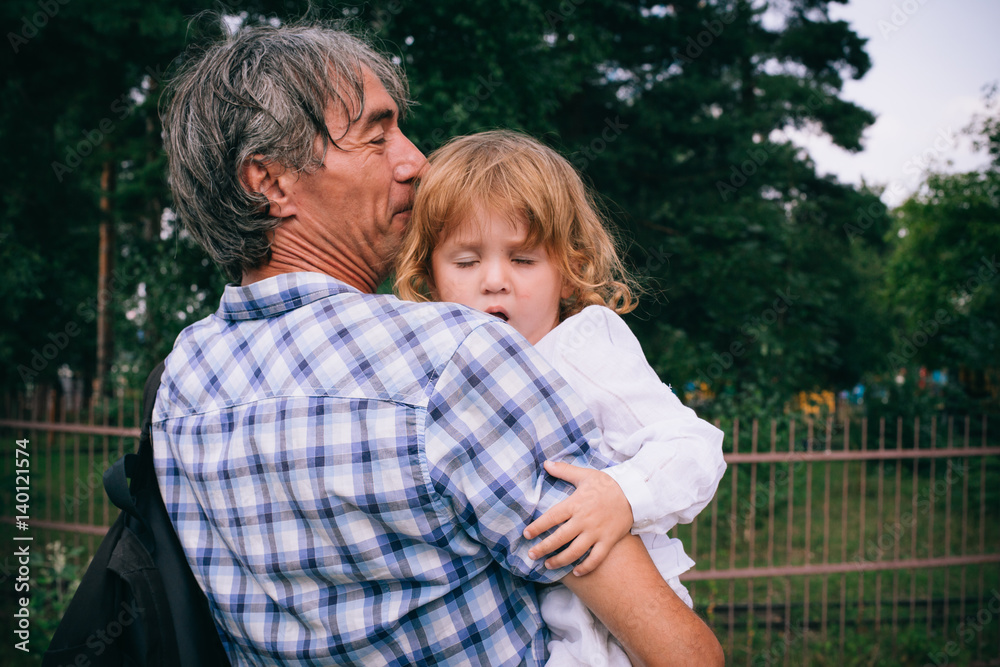 Family girl in the arms of his father outdoors. Family girl in the arms of his father outdoors.