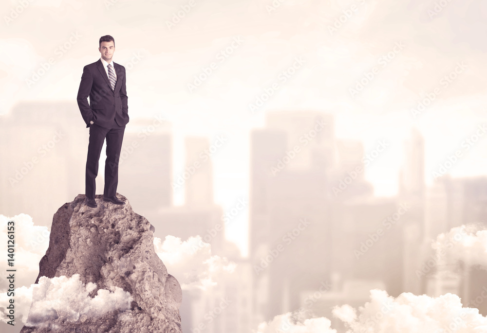 Confident businessman on dangerous cliff Confident businessman on dangerous cliff