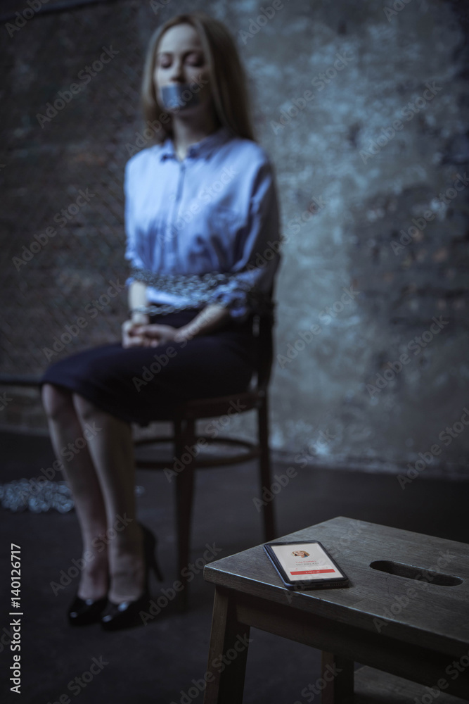 Hopeful scared woman looking at the phone Hopeful scared woman looking at the phone