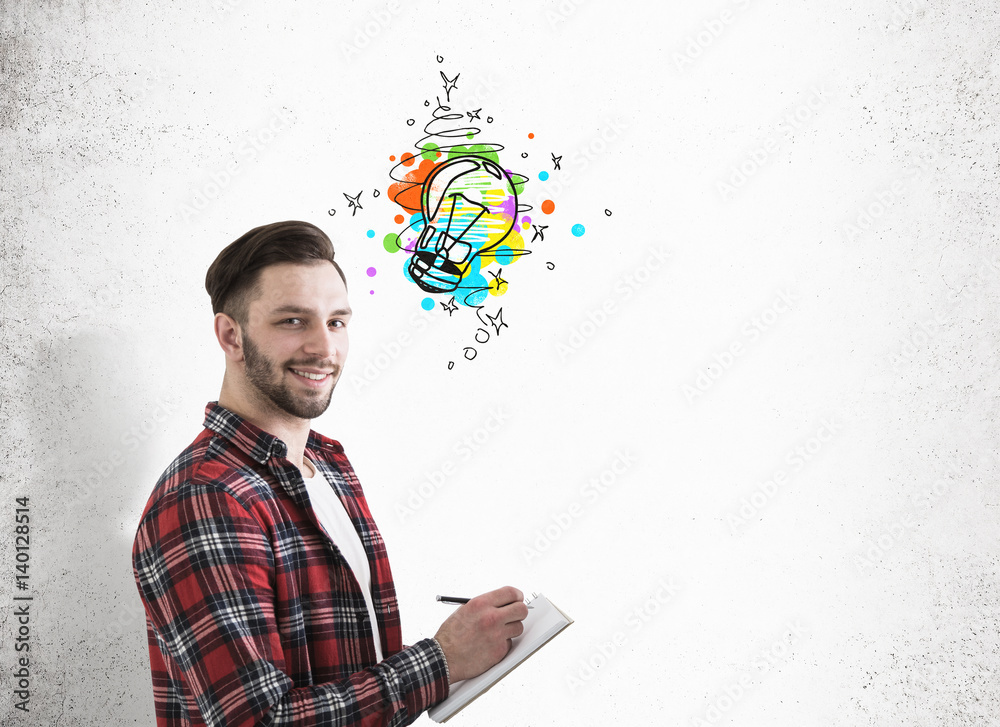 Hipster guy with a notebook, small light bulb Hipster guy with a notebook, small light bulb