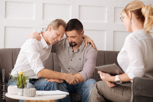 Delighted peaceful gay couple expressing their feelings photo