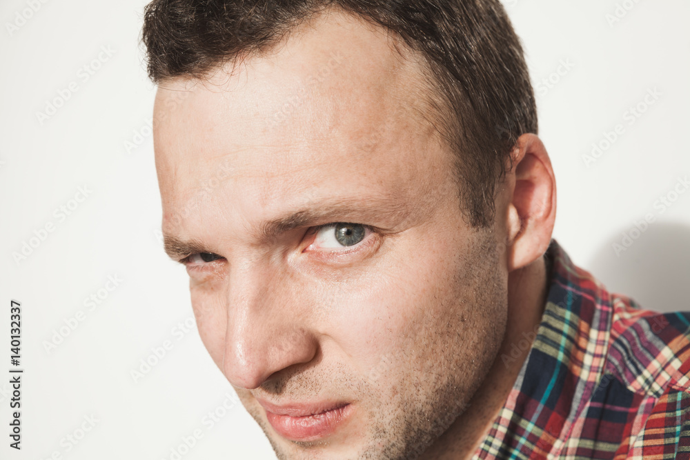 Young adult Caucasian man looks at camera Young adult Caucasian man looks at camera