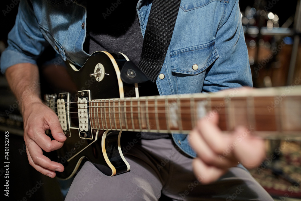man playing guitar at studio rehearsal man playing guitar at studio rehearsal