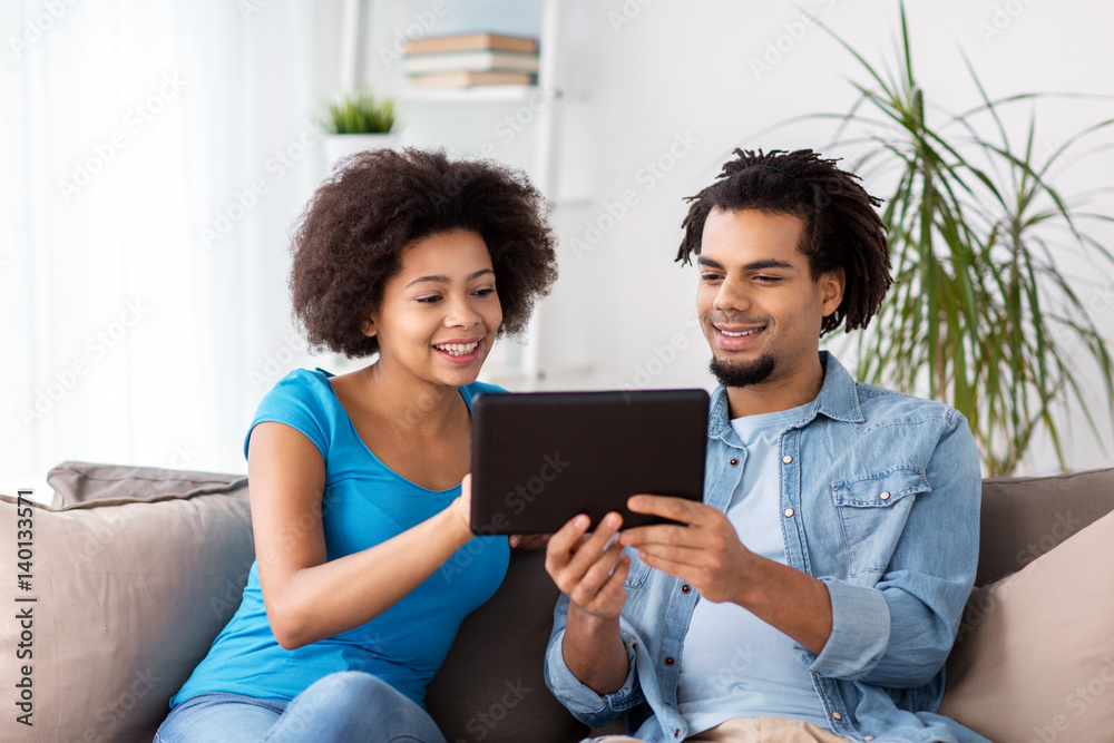 smiling happy couple with tablet pc at home smiling happy couple with tablet pc at home