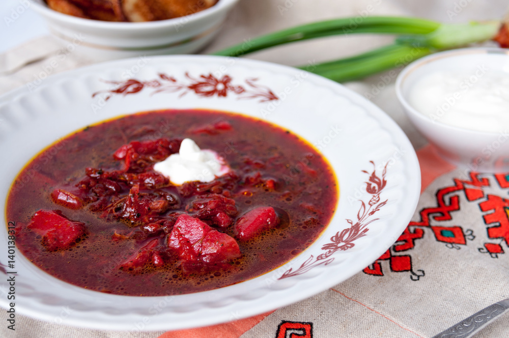 Ukrainian borsch made from beets with sour cream on table Ukrainian borsch made from beets with sour cream on table