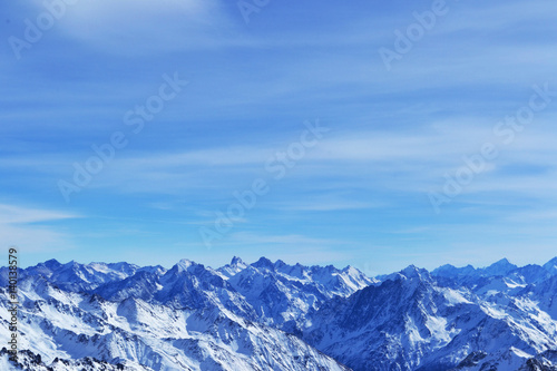snow peaks  ridge  blue sky  floating clouds. beautiful view from ski slope.