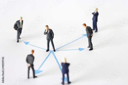 Businessmen figurines and arrows