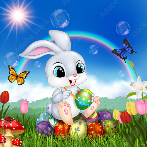 Cartoon rabbit decorating an Easter egg