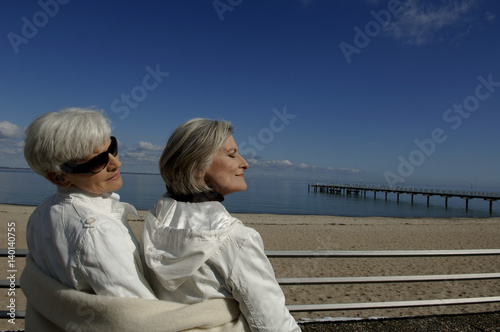 Two mature women chilling at Baltic Sea beach