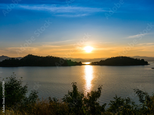 Beautiful Sunset between two island on tranquil lake