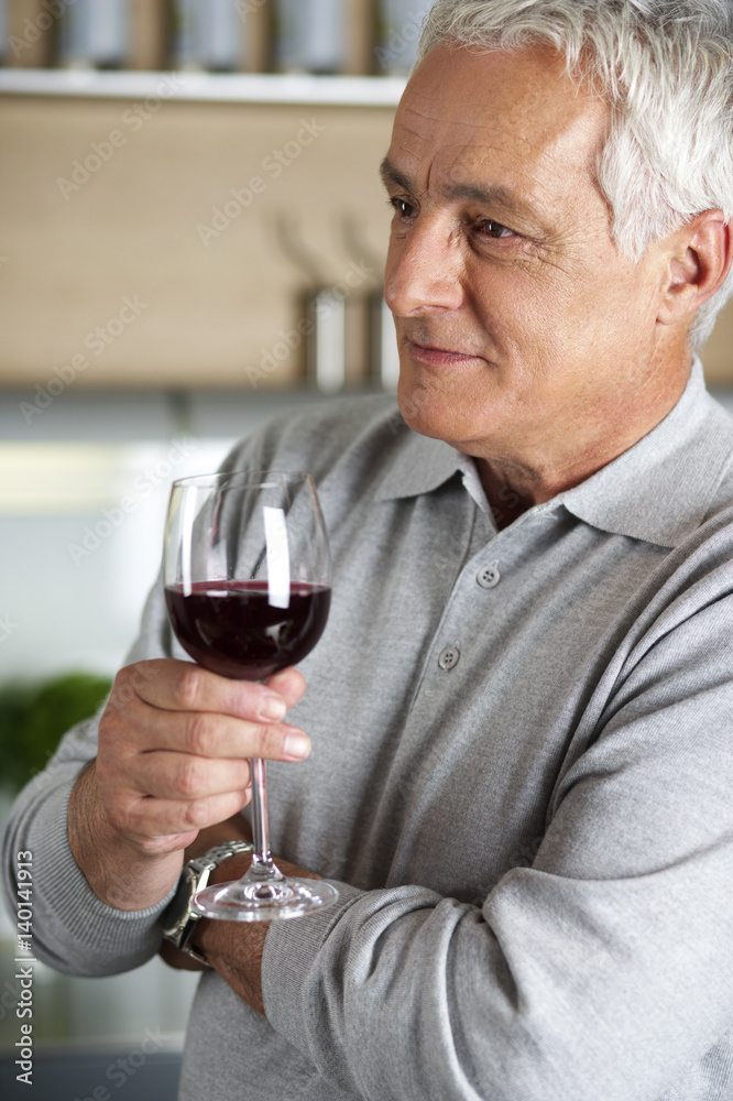 Gray-haired man with a glass of wine in his hand, close-up Gray-haired man with a glass of wine in his hand, close-up