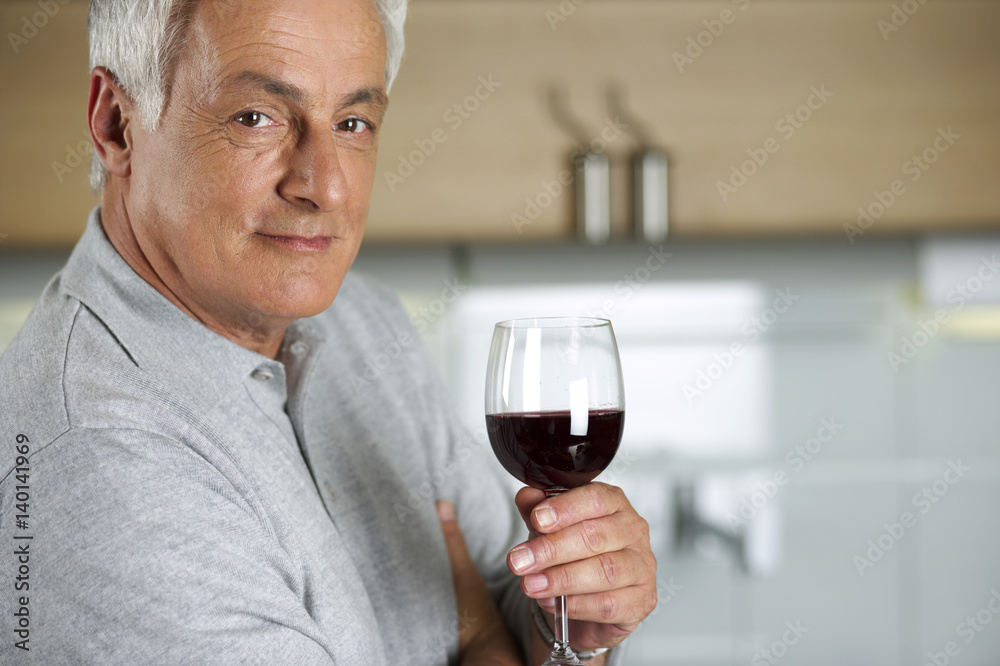 Gray-haired man with a glass of wine in his hand, close-up Gray-haired man with a glass of wine in his hand, close-up