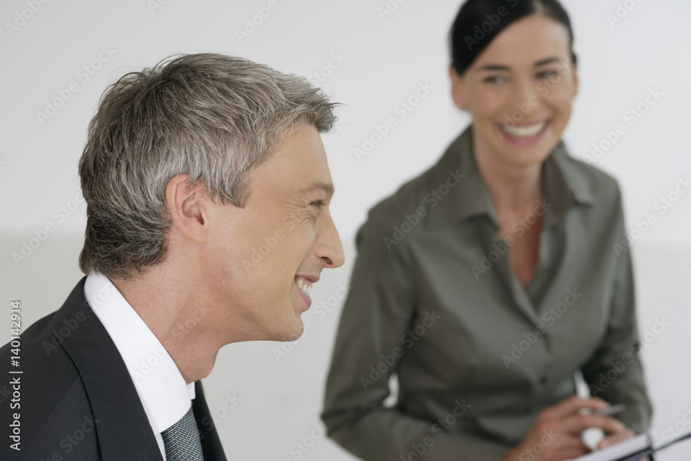 Manager and business woman laughing during meeting Manager and business woman laughing during meeting