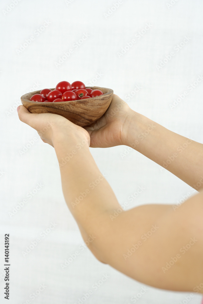 Woman holding a bowl with cherry tomatoes Woman holding a bowl with cherry tomatoes