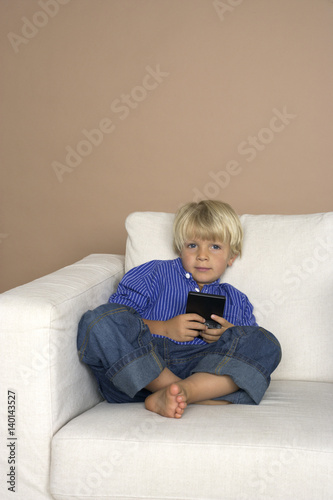 Boy (4-5 Years) playing hand held computer game