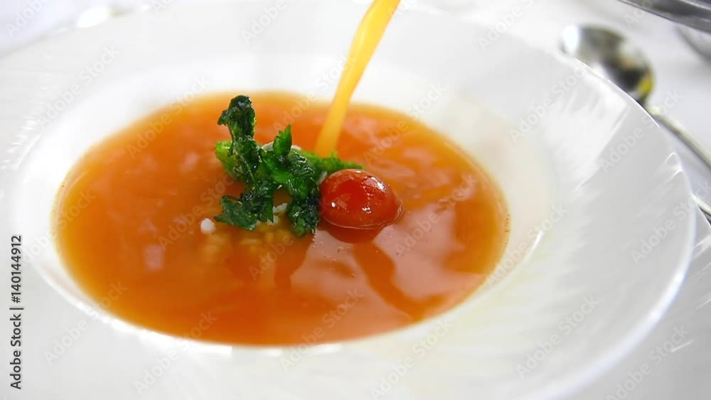fresh tomato soup with bread dipped in pesto