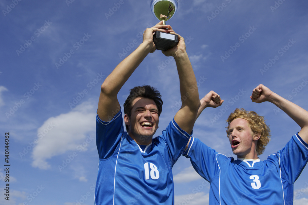 Cheering kickers holding a cup Cheering kickers holding a cup