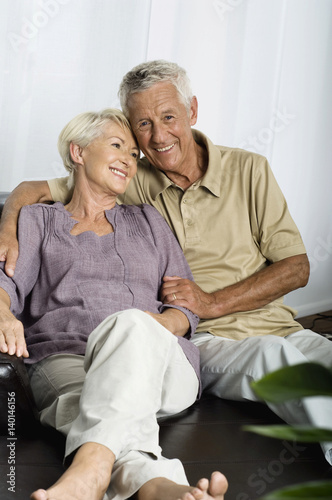 Senior couple sitting on sofa