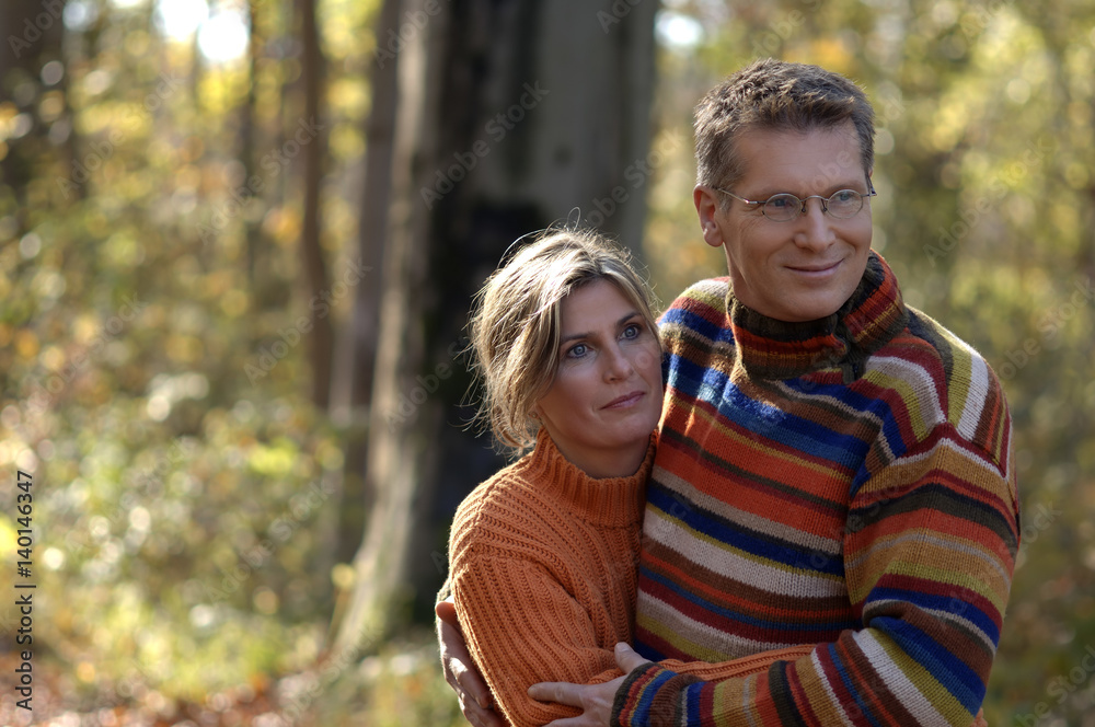 Mid adult woman and man embracing each other in a park