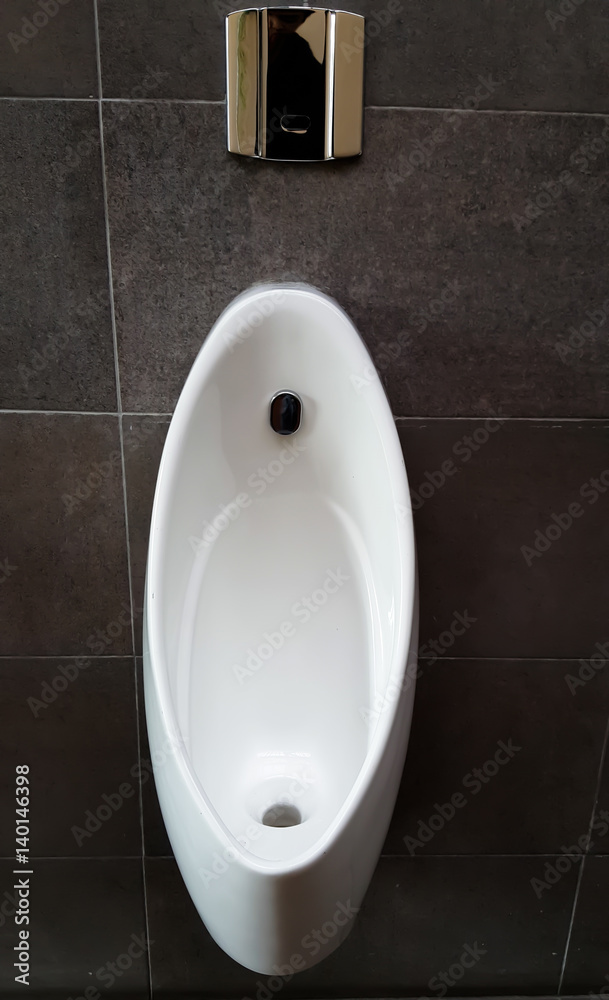 Fototapeta premium line of white porcelain urinals in public toilets