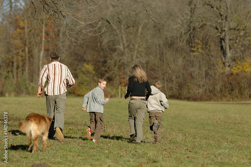 Family group and dog moving over open space