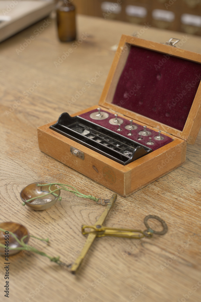 An old-fashioned scale and a box with weights An old-fashioned scale and a box with weights