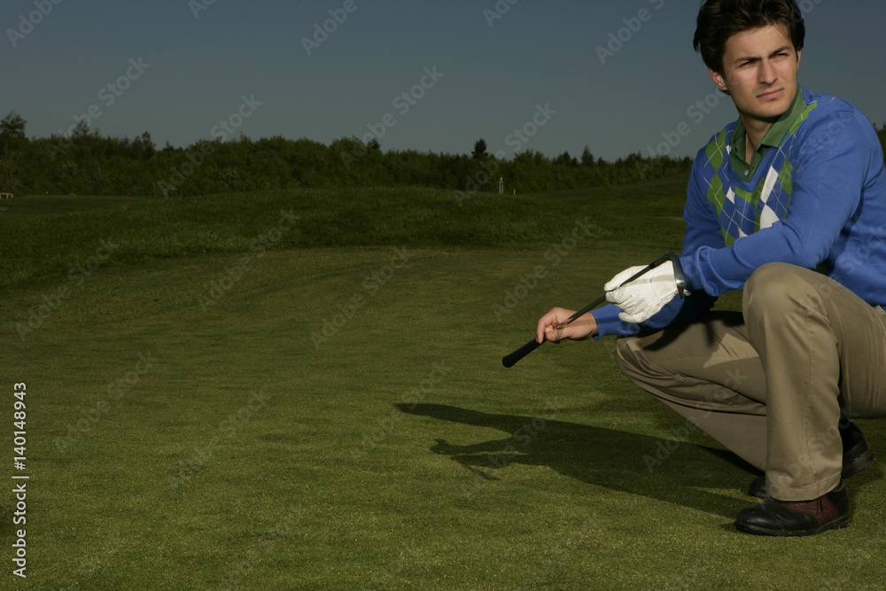 Fototapeta premium Young man on golf course