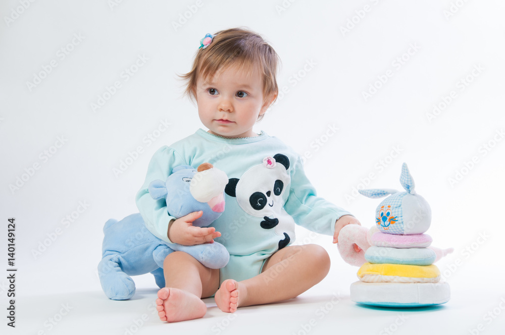 Portrait of a smiling child with a toy bear, isolated on a white background Portrait of a smiling child with a toy bear, isolated on a white background