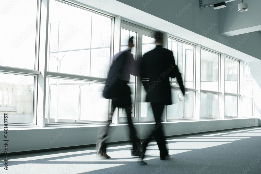 Two businessmen passing