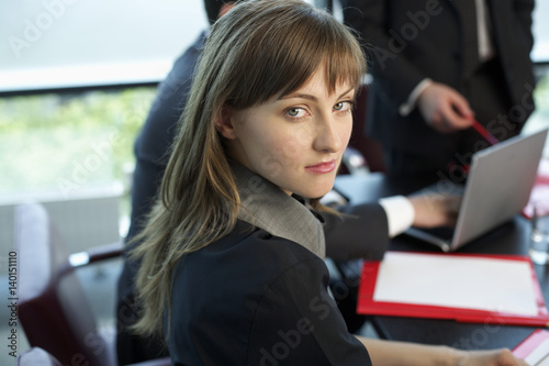 Businesswoman in a meeting looking at camera © Gudrun