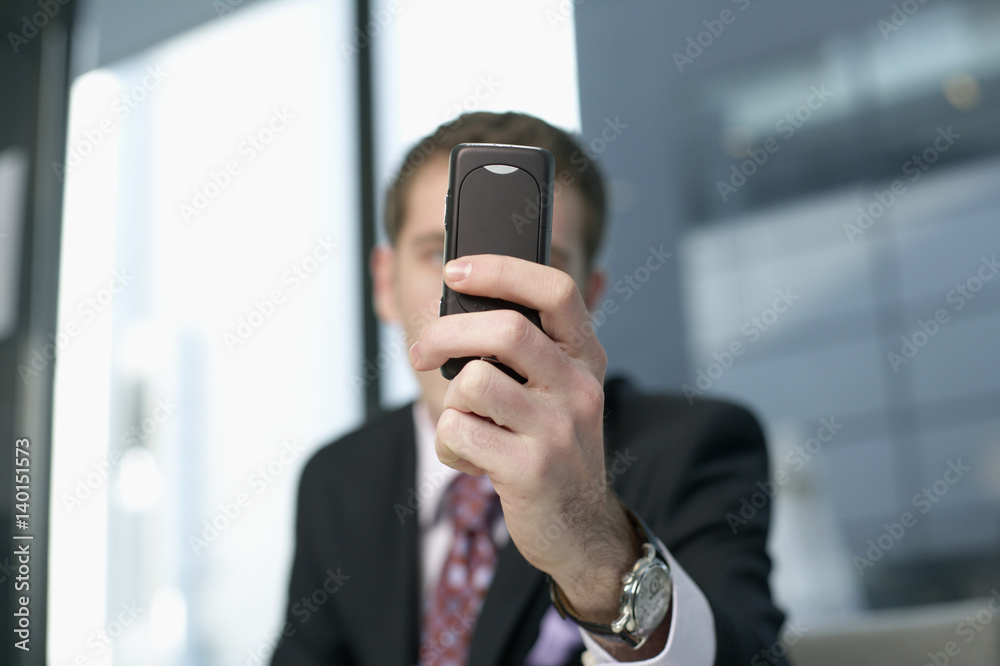 Fotografie Businessman holding a mobile
