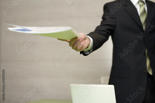 Businessman handing over documents