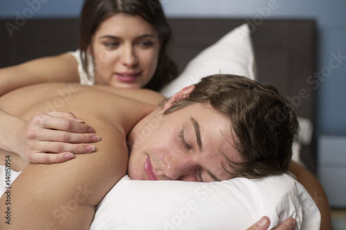 Young couple in bed, selective focus © Gudrun