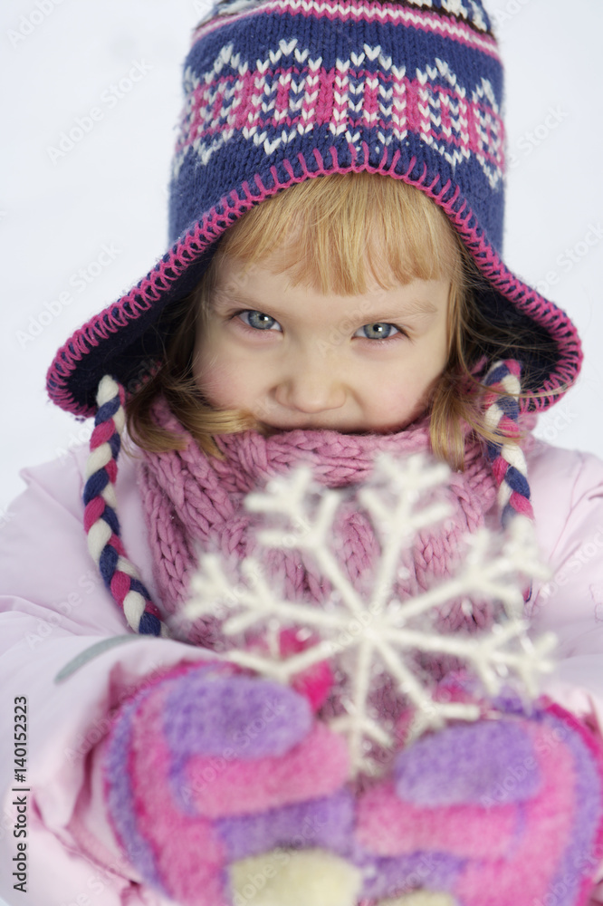 Girl holding a snowflake at camera Girl holding a snowflake at camera