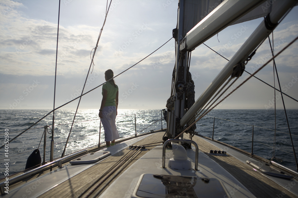 Fototapeta premium Woman standing on a sailing yacht