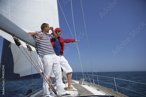 Two men standing on a boat