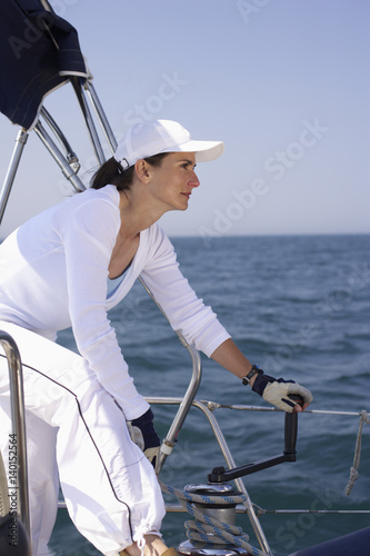 Woman on a boat handling a winch