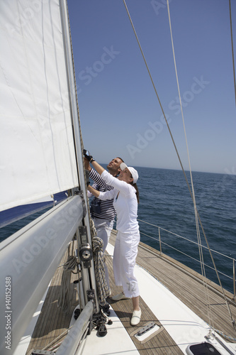 Two people working on a sailing yacht © Gudrun