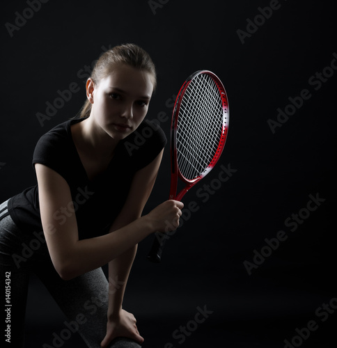 Portrait of sporty teen girl tennis player with racket © kulichok