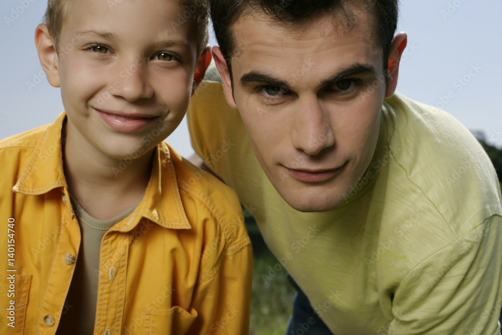 Father and son looking at camera Father and son looking at camera