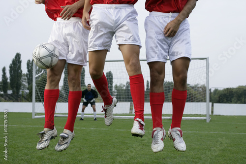 Soccer players forming a wall photo