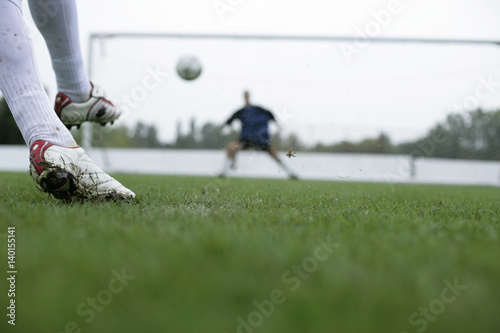 Soccer player kicking a goal