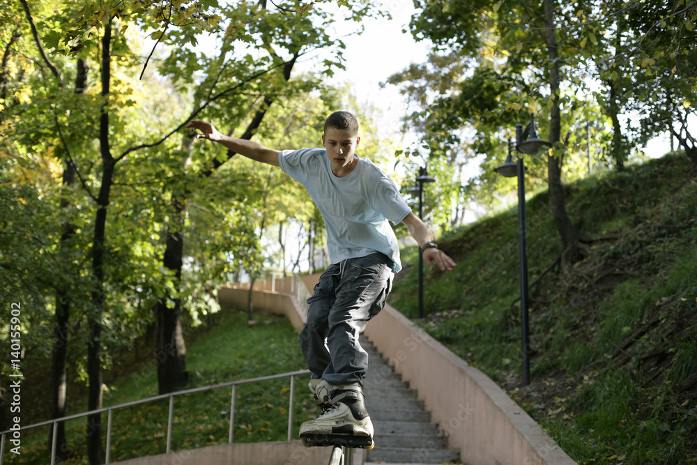 Boy inline skating over a balustrade