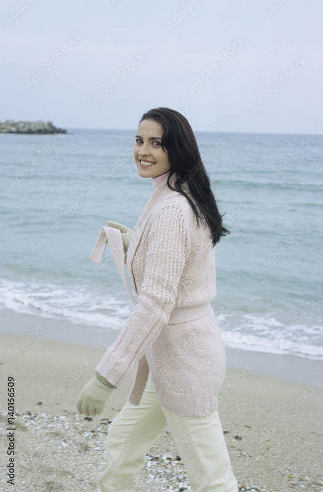 Young brownhaired Woman with Cardigan at the Beach - Season - Nature Young brownhaired Woman with Cardigan at the Beach - Season - Nature
