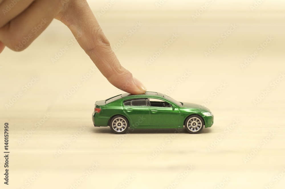 Finger pushing green toy car Stock Photo Adobe Stock