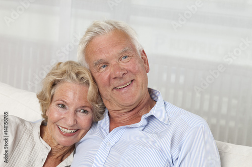 Happy senior couple on sofa