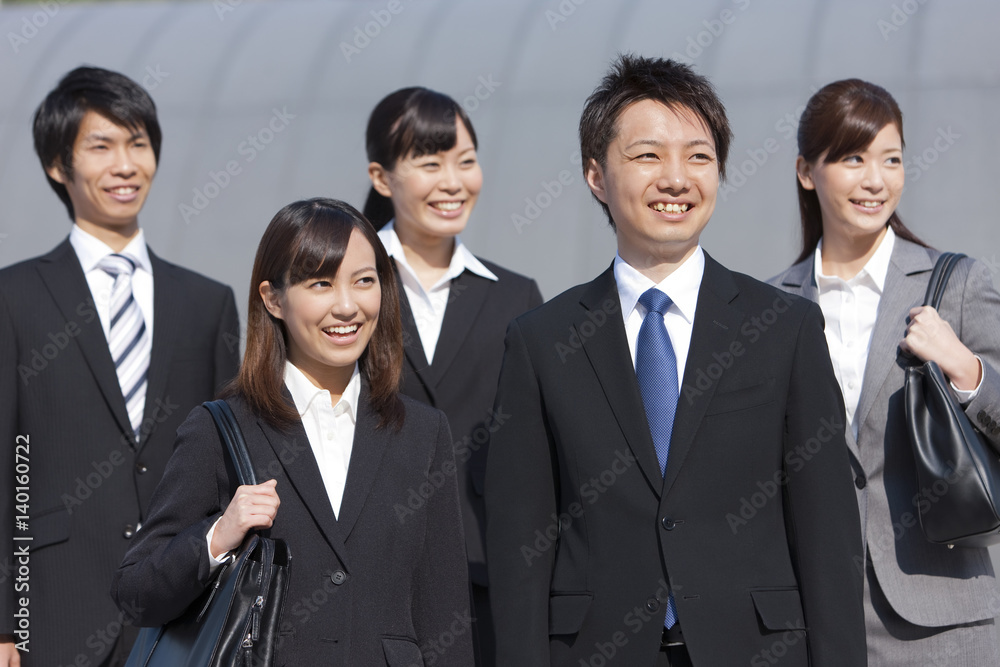Young business people standing outdoors Young business people standing outdoors