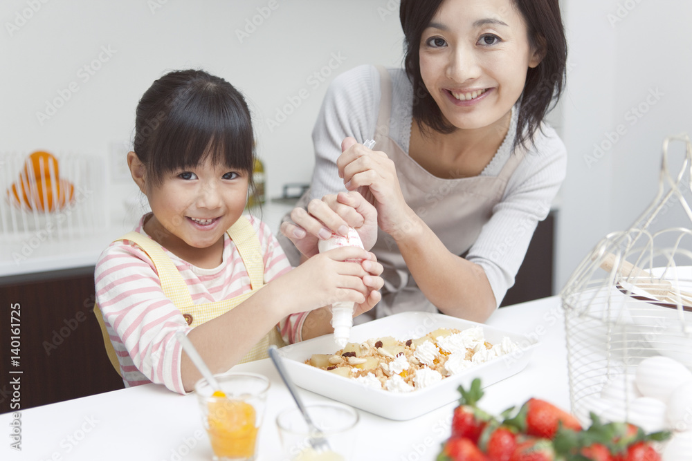Mother and daughter making sweets in the kitchen Mother and daughter making sweets in the kitchen